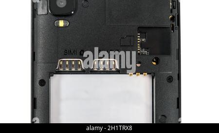 Slot for dual SIM cards and sd card, on a cell phone, mobile phone, smartphone close-up macro detail, isolated over white background Stock Photo