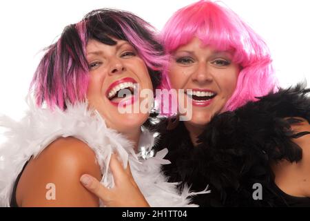 Portrait of Two Pink And Black Haired Smiling Girls with Boas Isolated on a White Background. Stock Photo