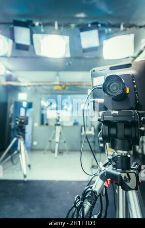 Film camera on a tripod in a television broadcasting studio Stock Photo