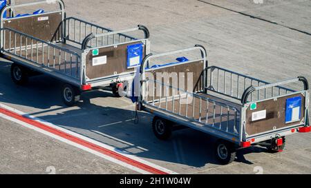 Image of empty luggage transportration cart in empty airport because of global economy crisis caused by coronavirus and COVD-19 pandemic. Stock Photo