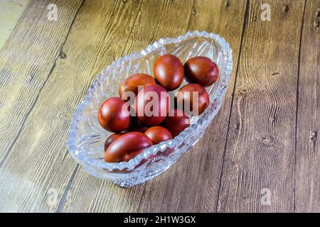 Painted Easter eggs in a crystal vase. Red painted chicken eggs for easter. Stock Photo