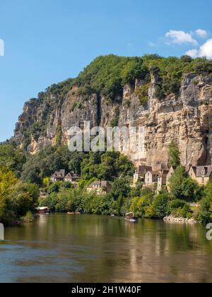 La Roque-Gageac, Dordogne, France - September 7, 2018: Canoeing and tourist boat, in French called gabare, on the river Dordogne at La Roque-Gageac an Stock Photo