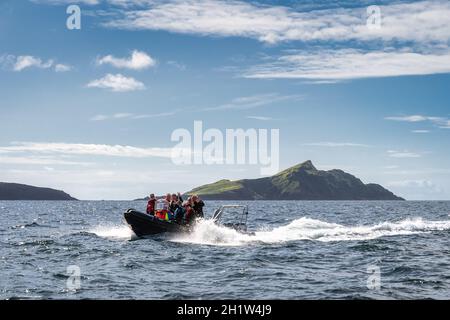 Portmagee, Ireland, August 2019 Happy group of tourists sailing on boat to visit Skellig Michael island where the Star Wars were filmed, Ring of Kerry Stock Photo