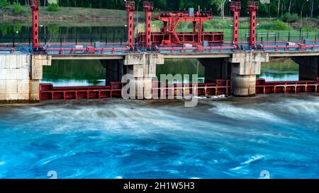River, dam, bridge. Car and pedestrian bridge in the morning. A full-flowing river with a strong current. Clean, bubbling, fresh water.Technical const Stock Photo