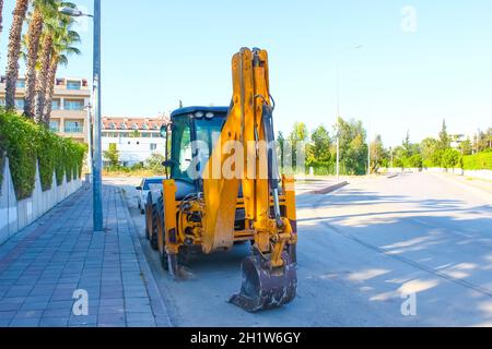 Mini bulldozer or excavation or loader on road. Construction, industry concept. Stock Photo