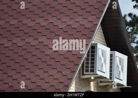 Decorative metal tile on a roof. Types of a roof of roofs. Stock Photo