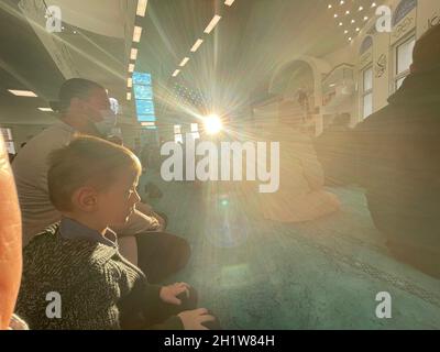 Dark tone, Muslim man praying with rosary beads in the hands against black background. Religion concept, praying hands. High quality photo Stock Photo