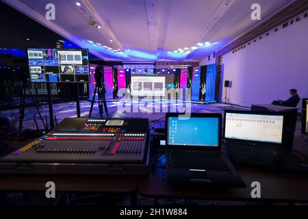 Live internet streaming of business conference meeting, presenter joining a seminar via video conference call in empty convention center. Online webin Stock Photo