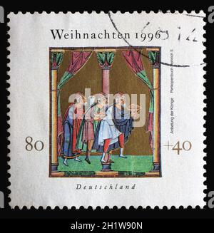 A Christmas stamp printed in Germany shows Adoration of the Magi, Illustration from Henry II's 'Book of Pericopes', circa 1996 Stock Photo