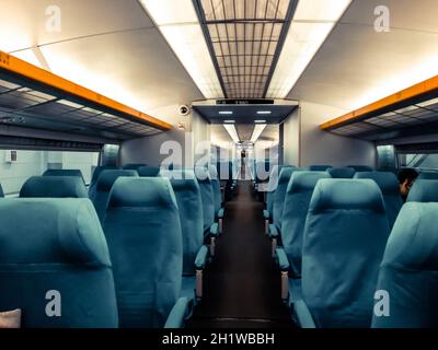 Interior view of modern intercity high speed train coach with rows