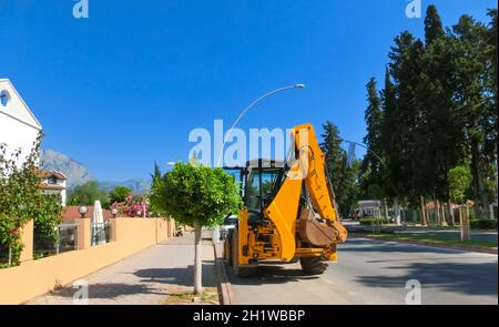 Mini bulldozer or excavation or loader on road. Construction, industry concept. Stock Photo