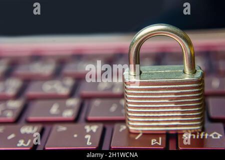 The silver padlock on keyboard laptop. The computer is cyber security. Stock Photo