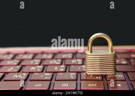 The silver padlock on keyboard laptop. The computer is cyber security. Stock Photo