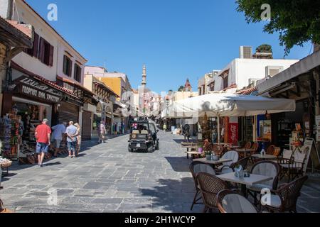 RHODES, Greece - JUN 07, 2021. After the Corona lockdown until the end of May, the first tourists walk again along the famous Socrates Street in the o Stock Photo