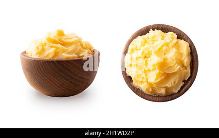 Ghee or clarified butter in wooden bowl, cooking oil, pure ghee isolated on white background. Clarified butter with copy space for text on white. Ghee Stock Photo