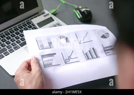 Man analyzing charts and graphs. Investment portfolio concept. Stock Photo