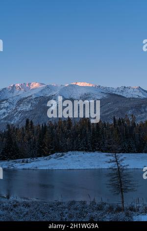 Sunrise view of a snow mountain and forest in Kanas, Xinjiang province, China. Stock Photo