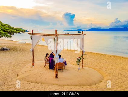 Surat Thani Thailand 25. Mai 2018 Romantic private dinner on honeymoon on the Bo Phut beach with Koh Phangan view on Koh Samui in Thailand. Stock Photo