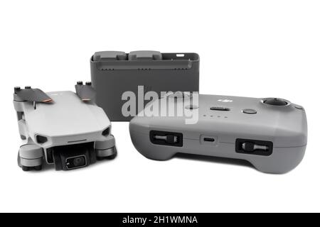 dji mini 2 fly more combo. Set of drone remote control and charging hub with batteries isolated on white background. 10.18.2021 Vinnytsia, Ukraine. Stock Photo