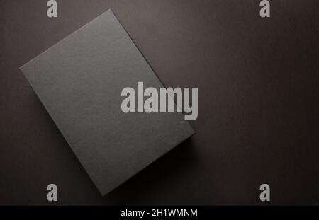 Black Friday sale advertising and branding concept, Gift box black against dark background, copy space, Winter season holiday promotion offer template Stock Photo