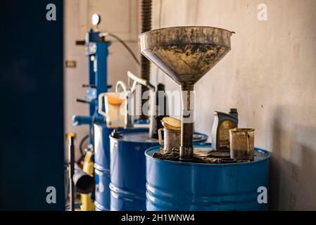 Used engine oil collection in a workshop, used oil barrel Stock Photo