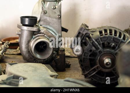 Worn turbine and alternator in a workshop bench Stock Photo