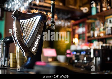 Bucharest, Romania - August 5, 2021: Illustrative editorial image of a Guinness beer tap in a pub in Bucharest.