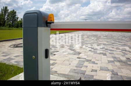 Close the gate. Automatic security system. Automatic entry system. Yellow light signal with a street barrier. Barrier gates Automatic security system Stock Photo