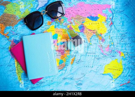 retro car on colorful world map, sunglasses, passport. Stock Photo
