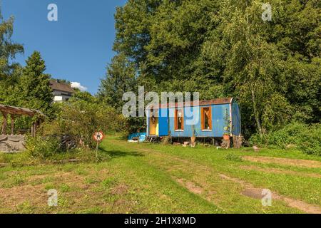 Old construction trailer converted into a caravan Stock Photo