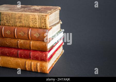 Stack of old books isolated on dark background Stock Photo
