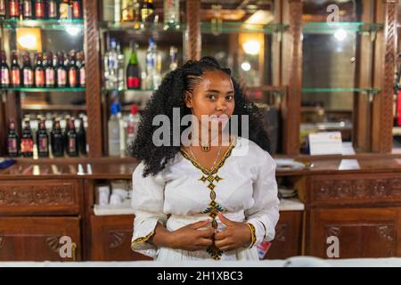 Mekele, Ethiopia - April 28, 2019: Ethiopian beautiful barmaid woman with traditional hair style in Mekelle, second largest city and capital of Tigray Stock Photo