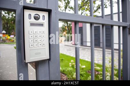 Video intercom on the gate at the entrance to the residential area. Electronic intercom to a private area. closed residential yard Stock Photo