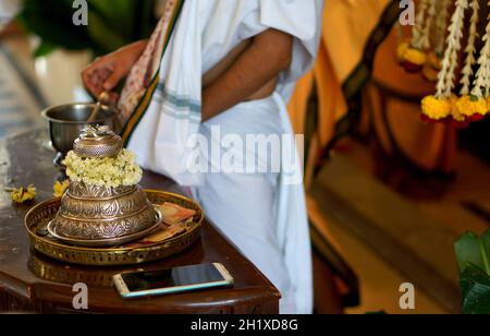 View of Satagopam in the shape of silver cap with  feet of Hindu god Vishnu,symbolically,and priest touch devotees head as blessing of deity in temple Stock Photo