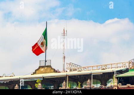 Mexican flag green white red with blue sky in the center of Mexico City in Mexico. Stock Photo