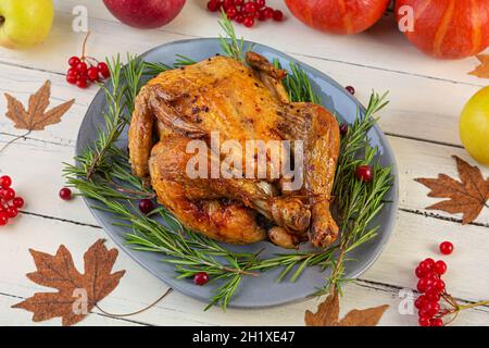 Baked whole chicken or turkey. Roasted homemade chicken with herbs. Thanksgiving day decoration Stock Photo
