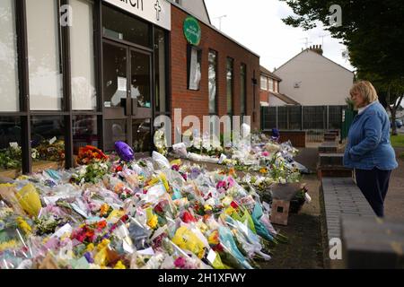 A woman looks at the floral tributes left outside the Belfairs Methodist Church in Leigh-on-Sea, Essex, where Conservative MP Sir David Amess was killed on Friday. Picture date: Tuesday October 19, 2021.