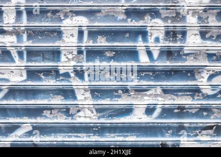 Violet metal shutter with peeling paint. Ideal use for background / wallpaper. Stock Photo