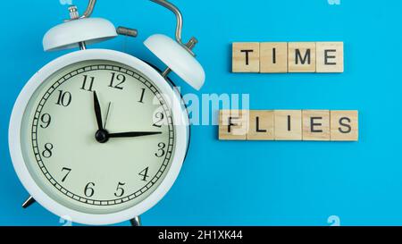 A quote for reminding people how important time is. A self motivation quote regarding time. Selective focus on the clock. Stock Photo