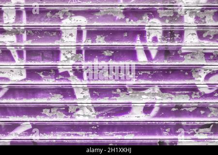 Violet metal shutter with peeling paint. Ideal use for background / wallpaper. Stock Photo