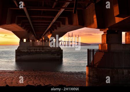 Unsual aspect of the M4 Second Severn Crossing, now called the Prince of Wales Bridge, from Aust side in England. With vivd sunset Stock Photo