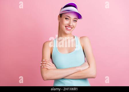 Photo of funky tail hairdo young sporty lady crossed arms wear hat turquoise top isolated on pink color background Stock Photo