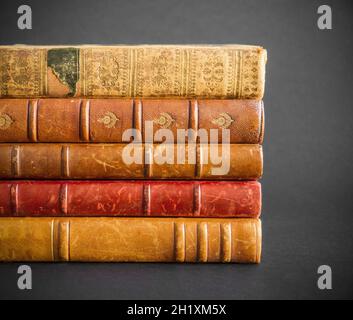 Stack of old books isolated on dark background Stock Photo