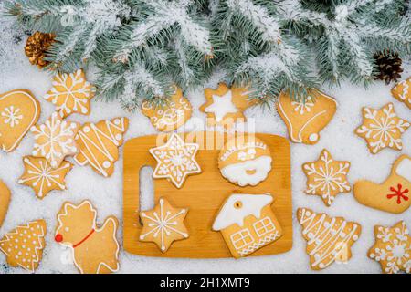 Pattern of gingerbread cookies in different shapes on a dark surface. Top view. Stock Photo