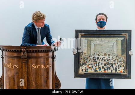London, UK. 19th Oct, 2021. L.S. Lowry ‘The Auction' - The Artist's Only Known Painting of an Auction Room makes its Auction Debut at Sotheby's London this November, with an Estimate of £1.2 - 1.8 Million. Credit: Guy Bell/Alamy Live News Stock Photo