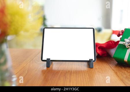 Tablet with copy space on screen lying on table with christmas decorations Stock Photo