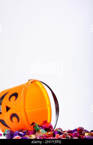 Composition of halloween bucket with trick or treat sweets on white background Stock Photo