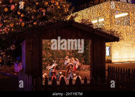 Nativity scene with christmas crib showing the holy family at traditional Christkindlmarkt near Hotel Terme, Meran(o) South Tyrol Italy Stock Photo