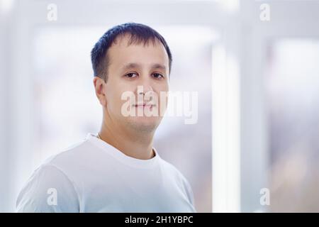 Portrait of caucasian man who is standing at home. Stock Photo