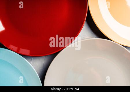 Clean different colour plates on the rustic background. Selective focus. Stock Photo